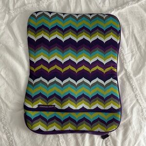 Johnathan Adler laptop case in purple, teal, green, white chevron pattern.